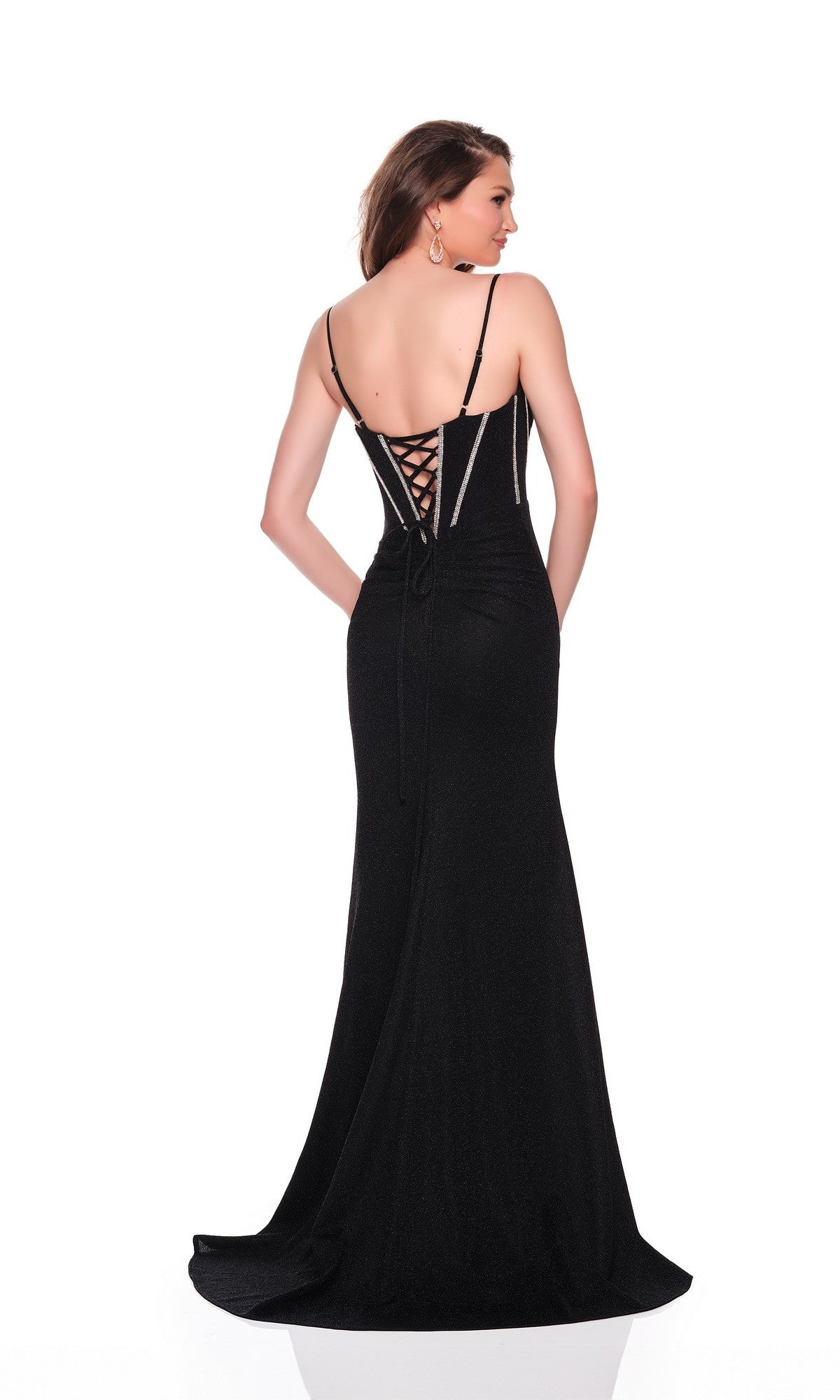 Woman wearing the Dave and Johnny 12804 long prom dress in black, featuring a lace-up back and thigh-high slit, standing with her back to the camera against a white background.